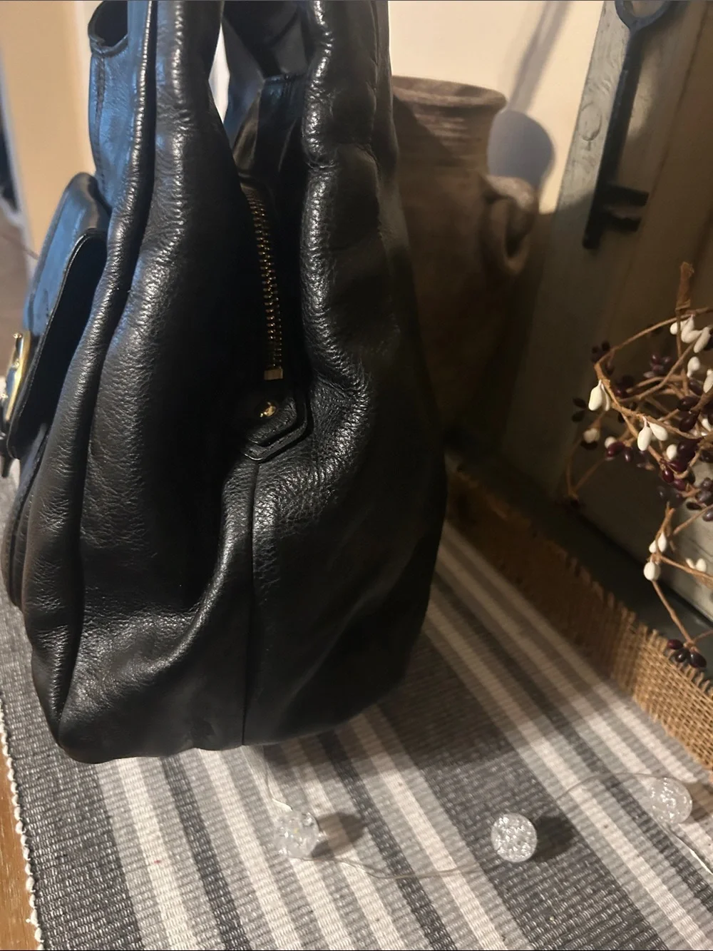 Coach Black Leather Shoulder Bag with Front Buckle Pocket and Gold Hardware